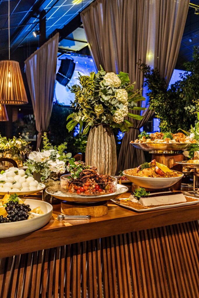 A beautifully arranged buffet table with floral decor in a restaurant setting.